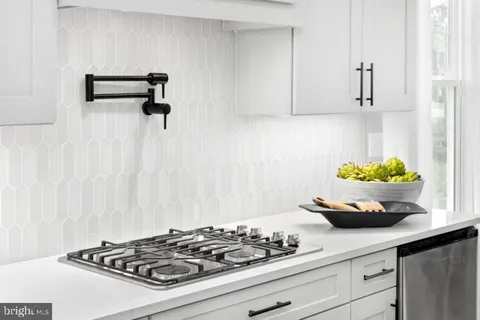 a kitchen with a stove and cabinets