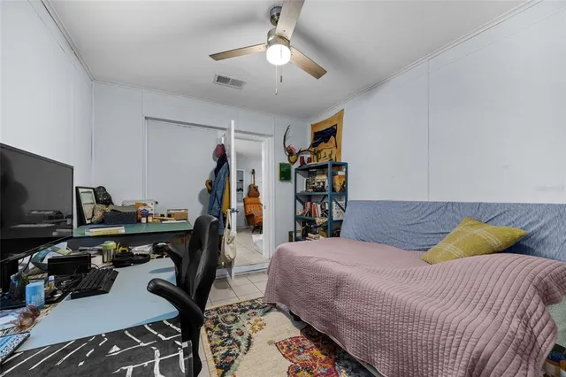 a bedroom with a bed gym equipment and a window