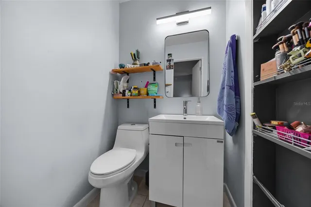 a bathroom with a sink toilet and mirror