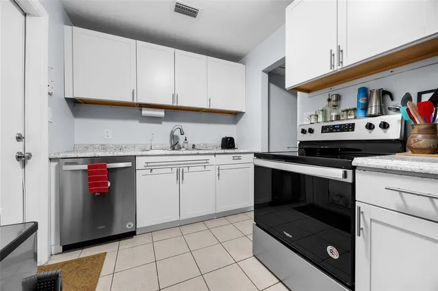 a kitchen with a stove cabinets and a sink