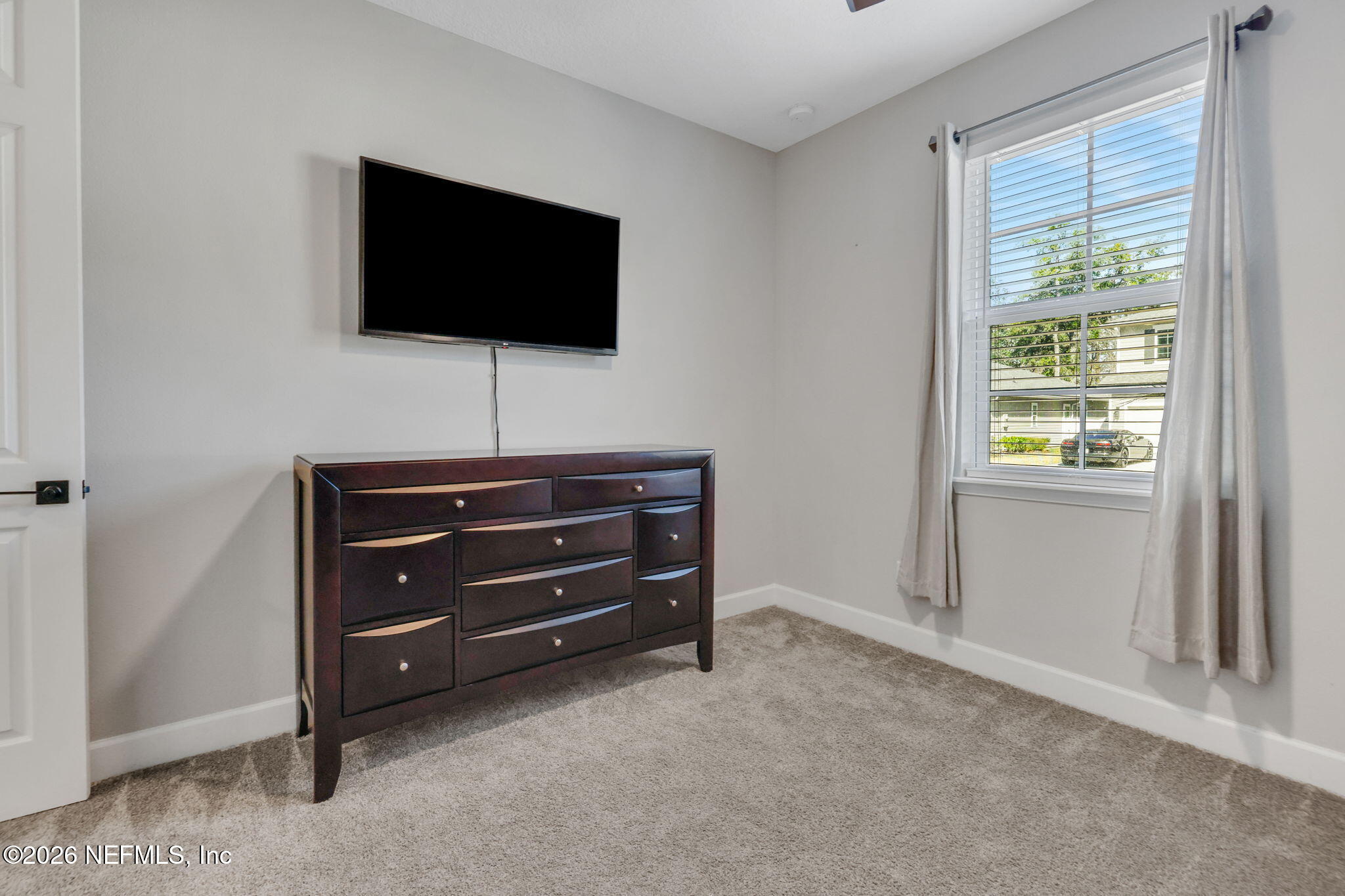 273 Little Bear Run St. Johns, FL 32259 - Photo 18 of 57 a room with a flat screen tv and a window