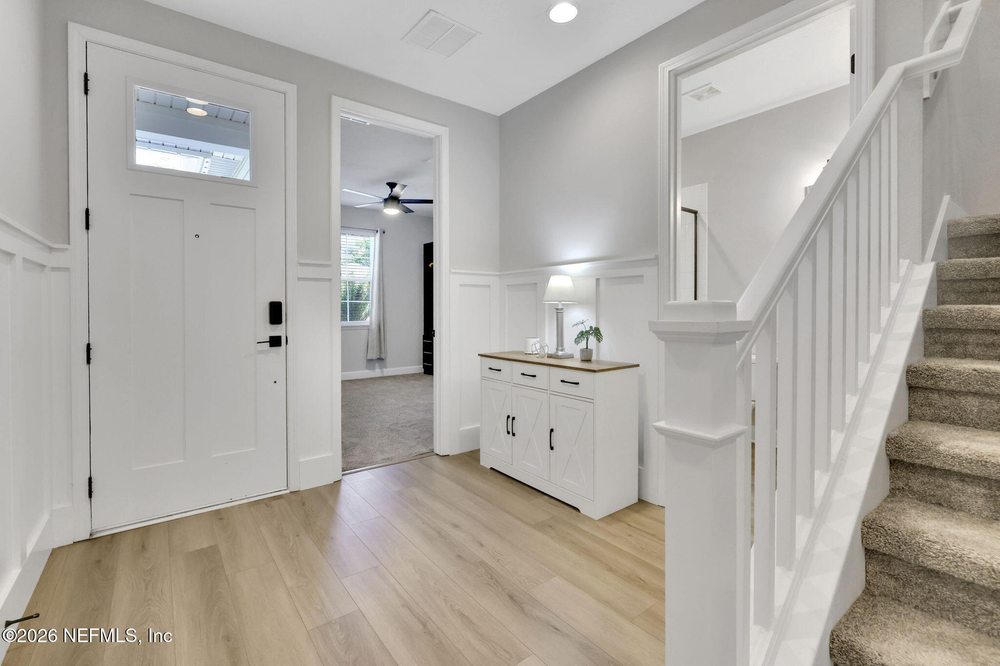 273 Little Bear Run St. Johns, FL 32259 - Photo 2 of 57 a view of a hallway with wooden floor stairs and a living room
