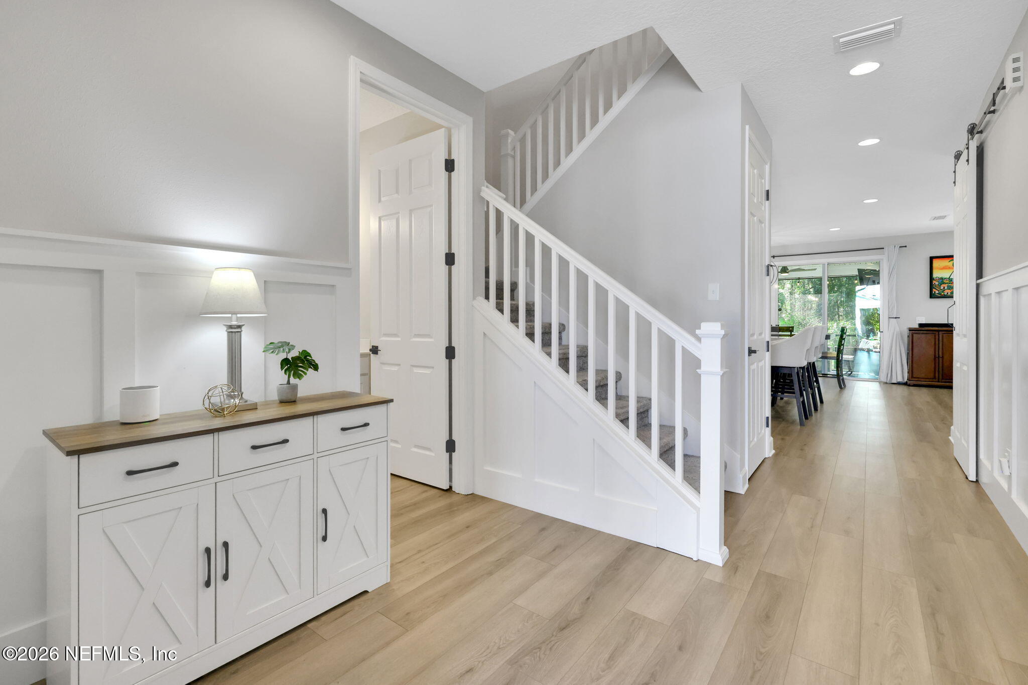 273 Little Bear Run St. Johns, FL 32259 - Photo 21 of 57 a hallway with white cabinets and wooden floor