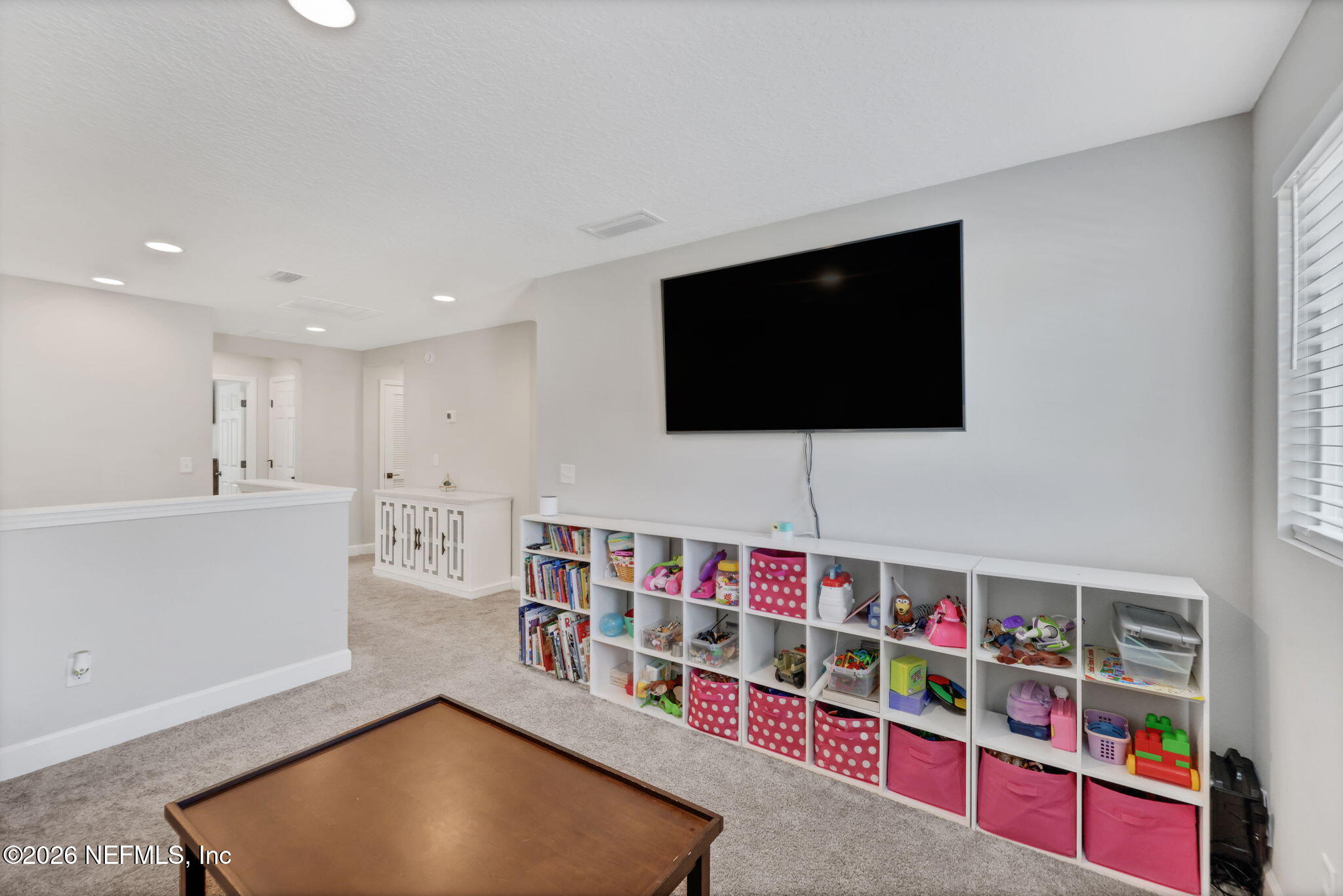 273 Little Bear Run St. Johns, FL 32259 - Photo 25 of 57 a living room with lots of books and a large window