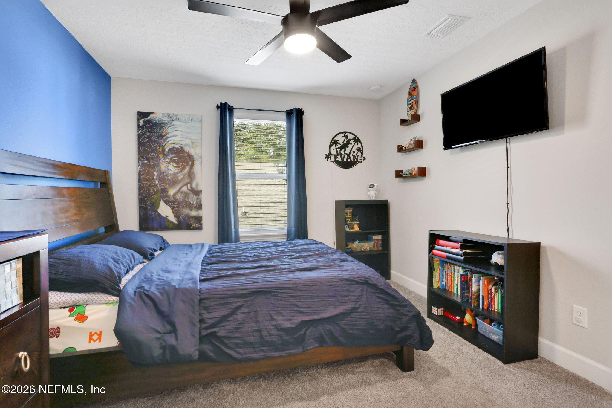 273 Little Bear Run St. Johns, FL 32259 - Photo 35 of 57 a bedroom with a bed a flat screen tv and a fireplace