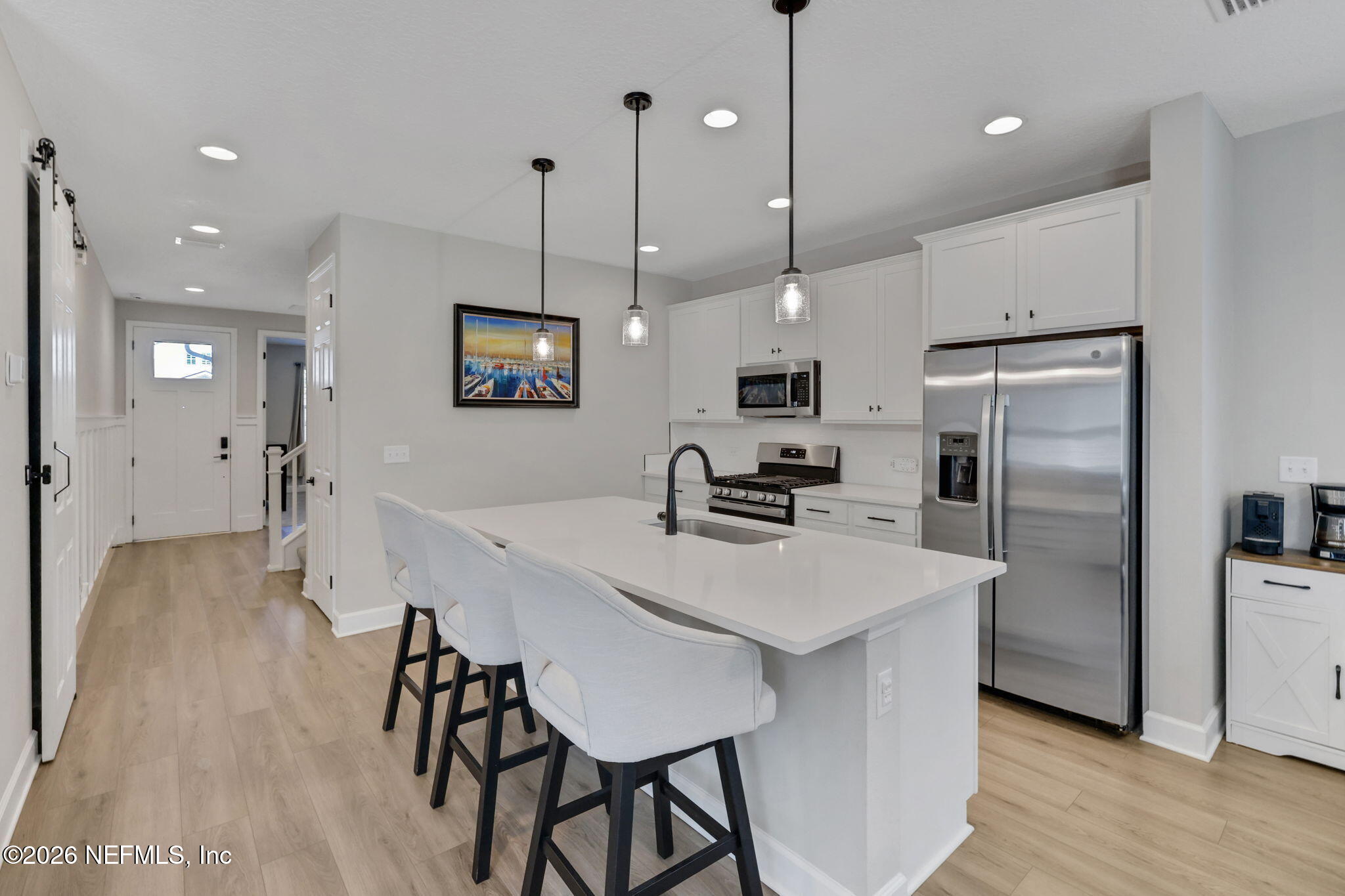 273 Little Bear Run St. Johns, FL 32259 - Photo 6 of 57 a kitchen with stainless steel appliances a table chairs refrigerator and microwave
