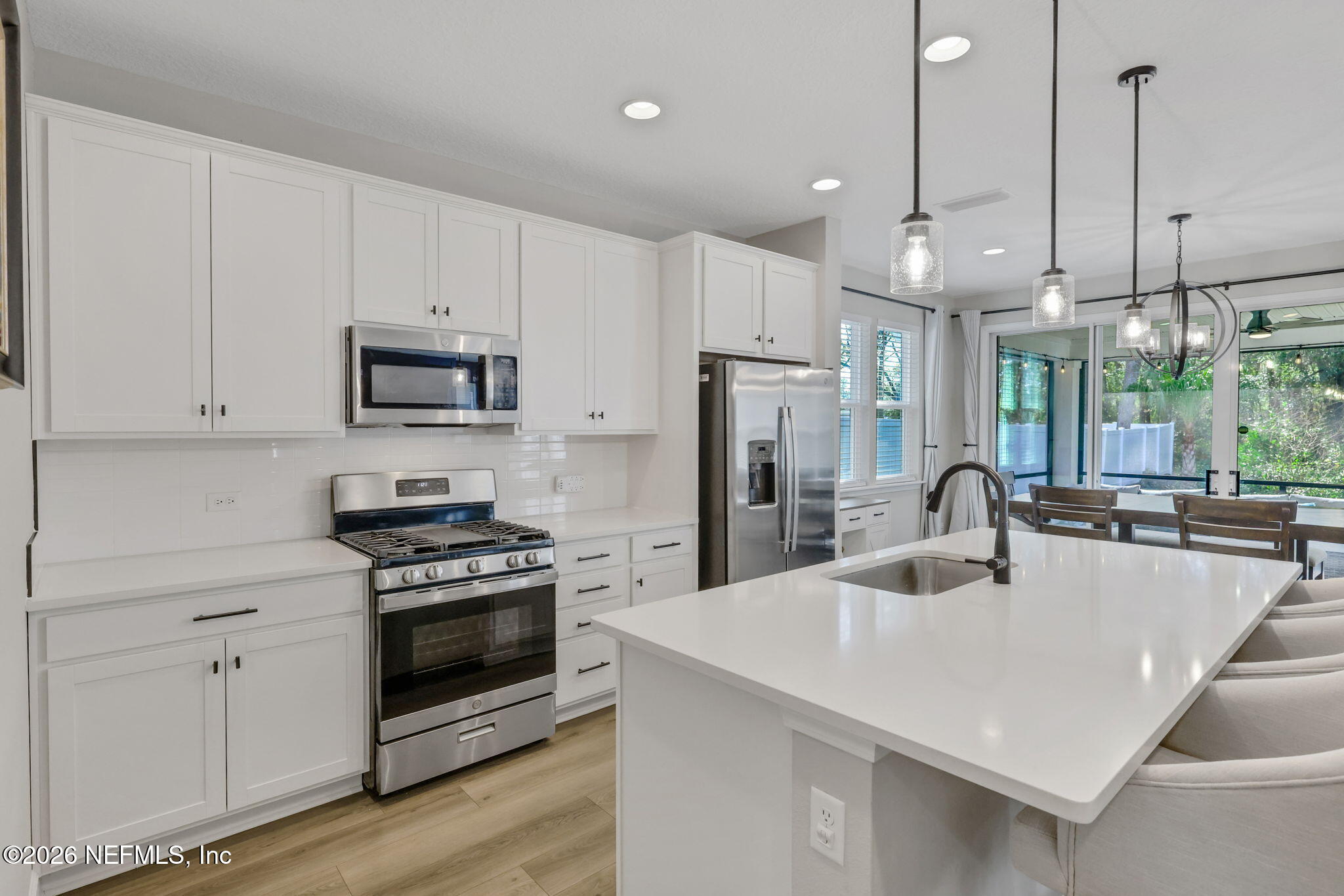 273 Little Bear Run St. Johns, FL 32259 - Photo 7 of 57 a kitchen with kitchen island a white counter top space a stove and a refrigerator