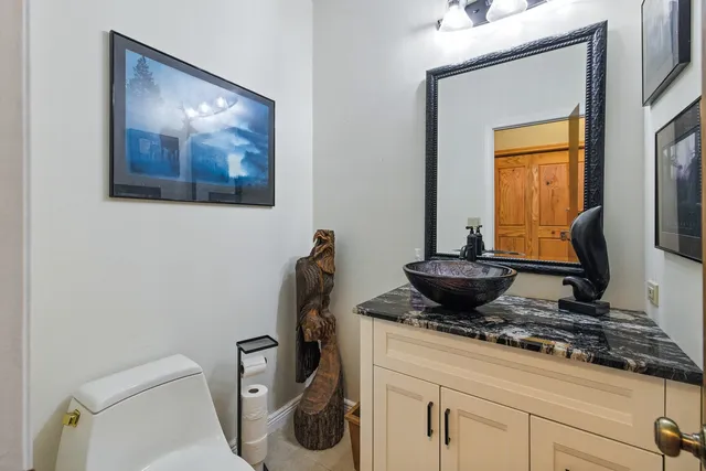 a living room with furniture a potted plant and a chandelier