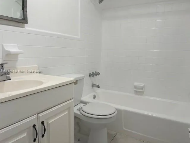 a white bath tub sitting next to a white toilet and sink