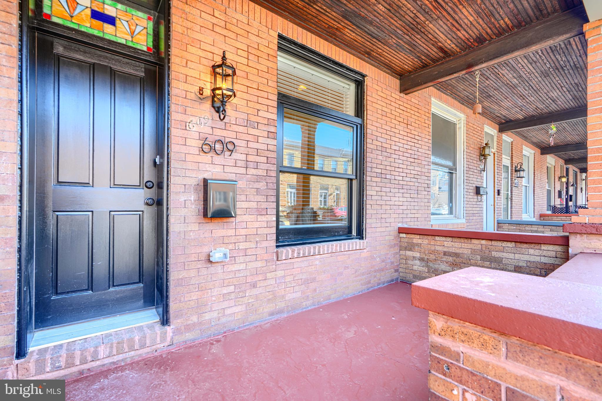 609 South Eaton Street Baltimore, MD 21224 - Photo 2 of 36 a front view of a house with large windows