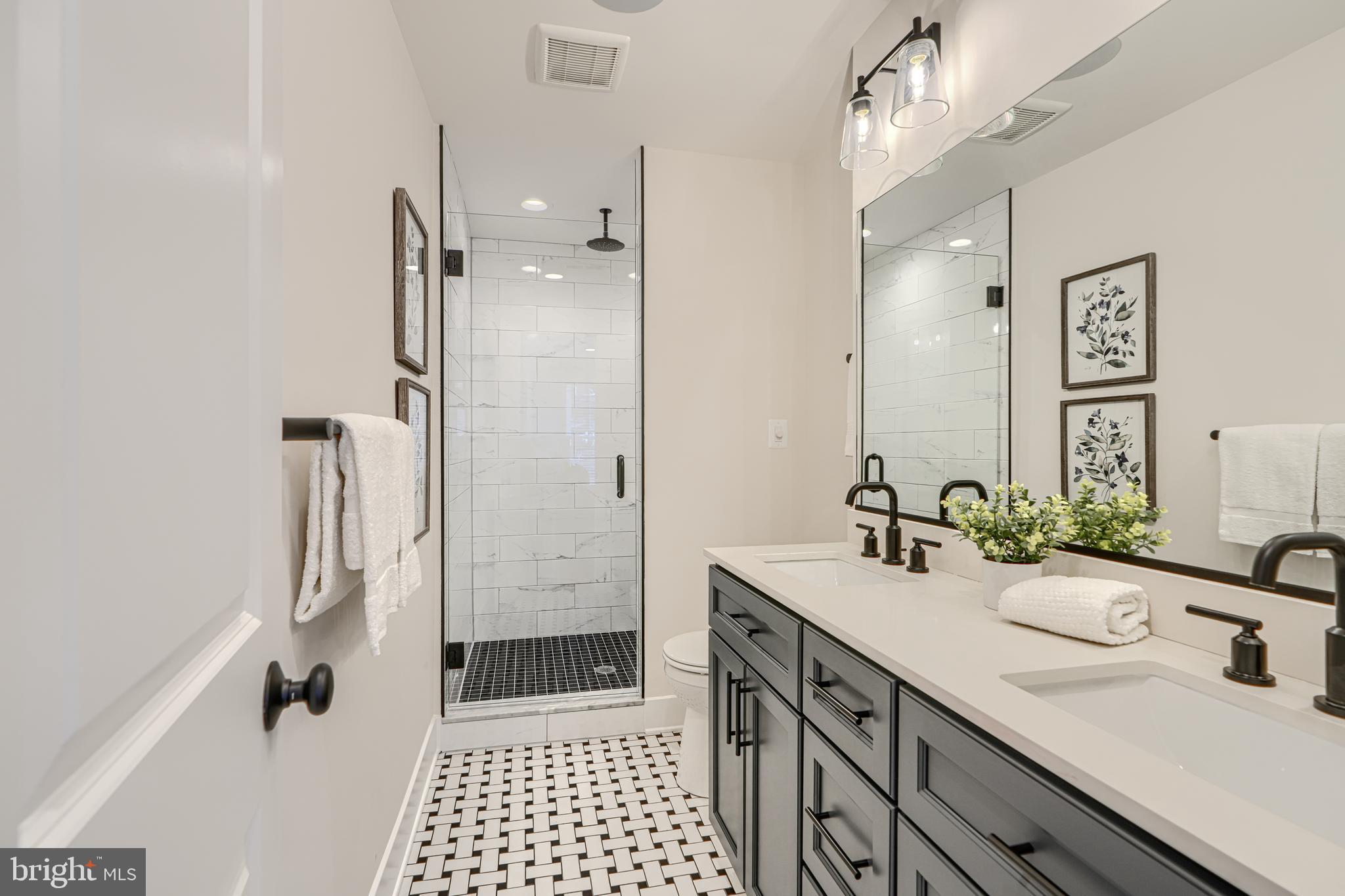 609 South Eaton Street Baltimore, MD 21224 - Photo 33 of 36 a bathroom with a sink double vanity and a shower