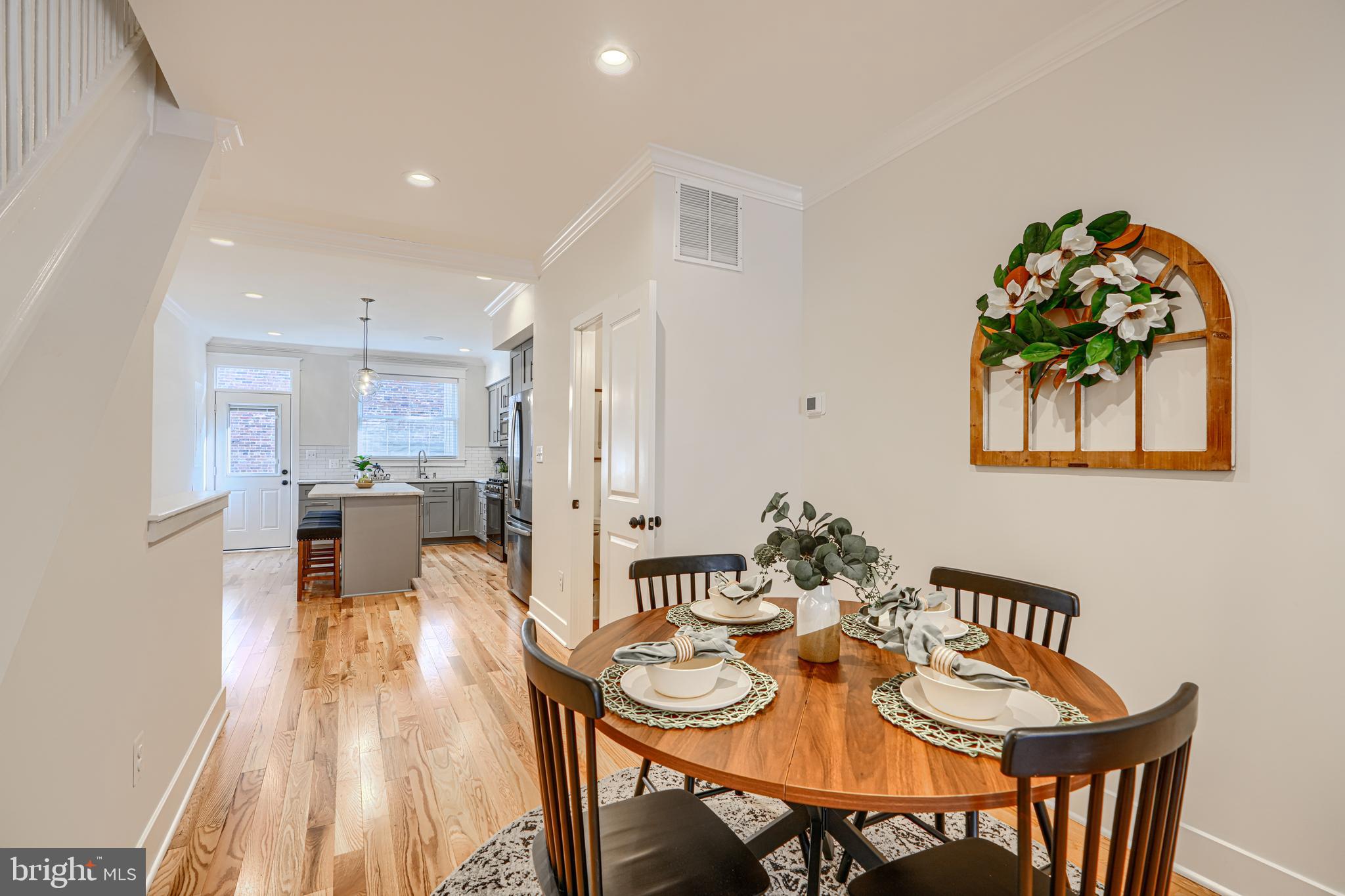 609 South Eaton Street Baltimore, MD 21224 - Photo 8 of 36 a view of a dining room with furniture and wooden floor