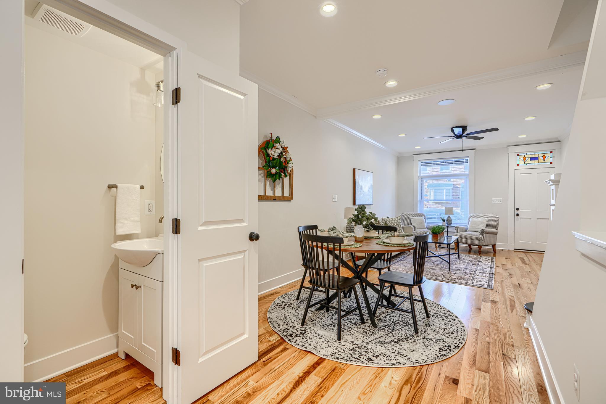 609 South Eaton Street Baltimore, MD 21224 - Photo 10 of 36 a view of a dining room with furniture and wooden floor