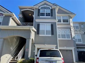 3325 South Kirkman Road, Unit 420 Orlando, FL 32811 - Photo 14 of 14 a front view of a house with parking space