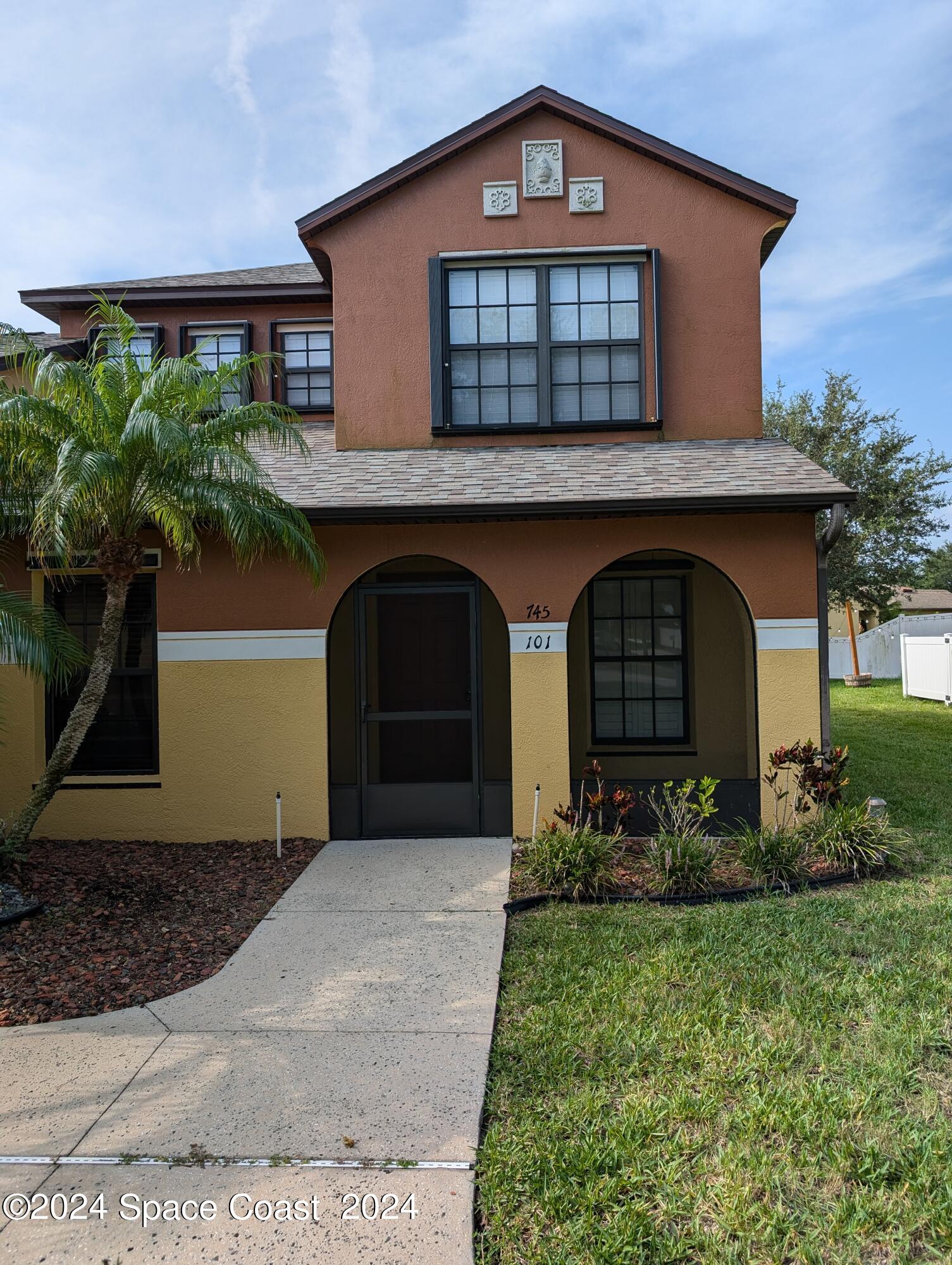 a front view of a house with garden