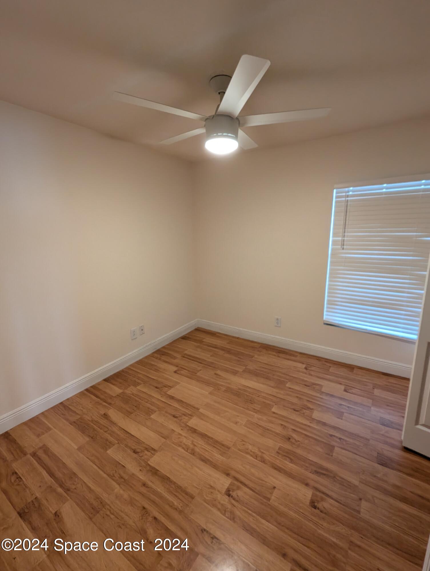 745 Luminary Circle, Unit 101 Melbourne, FL 32901 - Photo 12 of 32 a view of empty room with wooden floor