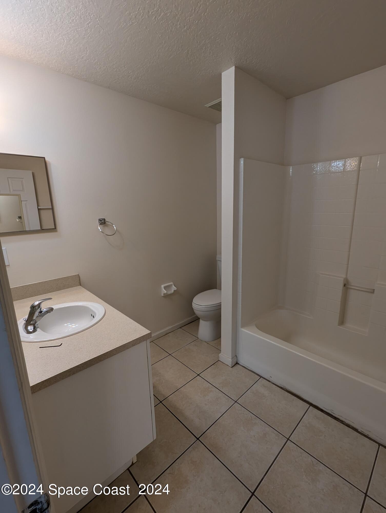 745 Luminary Circle, Unit 101 Melbourne, FL 32901 - Photo 22 of 32 a bathroom with a sink a toilet and shower
