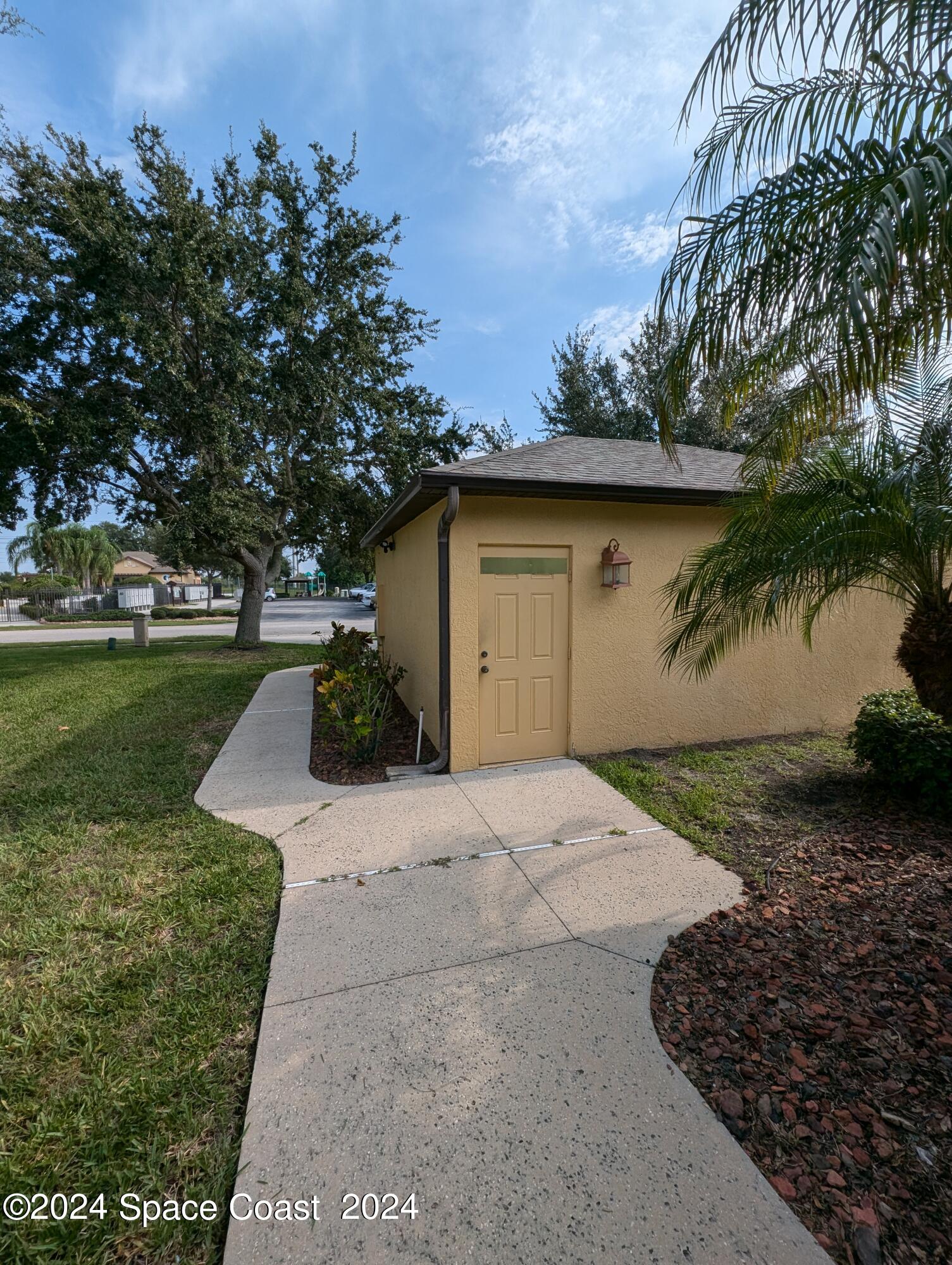 745 Luminary Circle, Unit 101 Melbourne, FL 32901 - Photo 27 of 32 a view of a backyard with plants and lake view