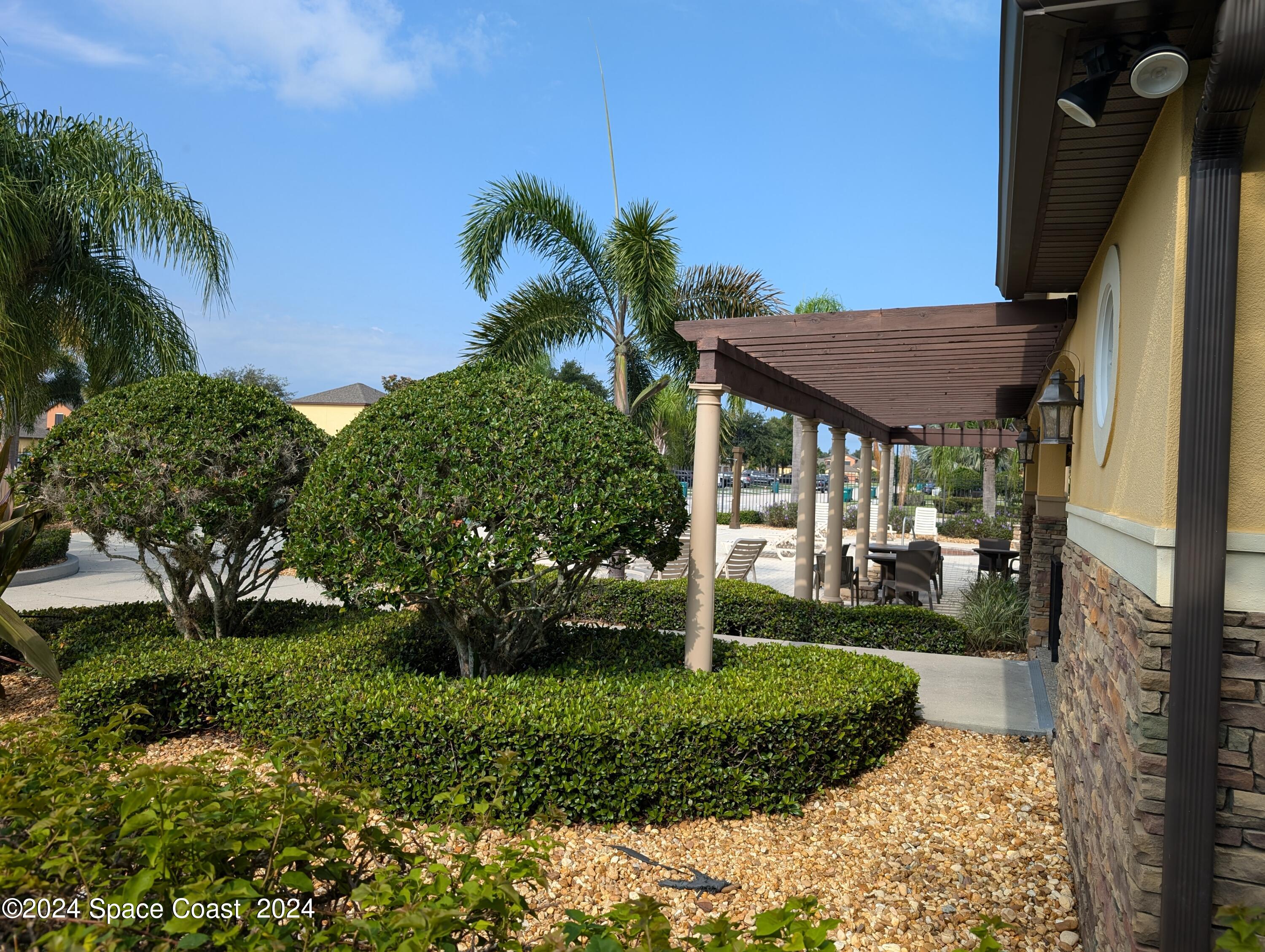 745 Luminary Circle, Unit 101 Melbourne, FL 32901 - Photo 32 of 32 a view of a house with a yard