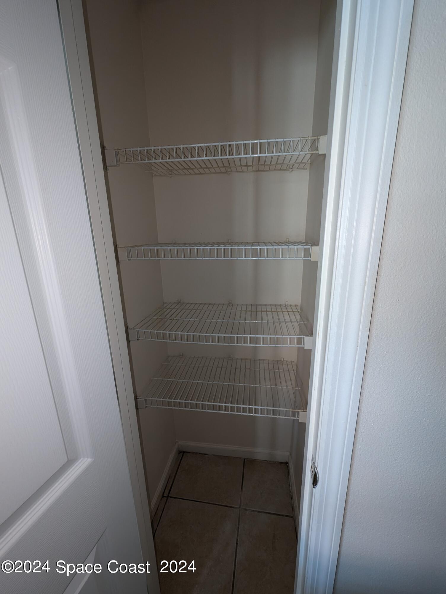 745 Luminary Circle, Unit 101 Melbourne, FL 32901 - Photo 5 of 32 a bathroom with a glass door shower