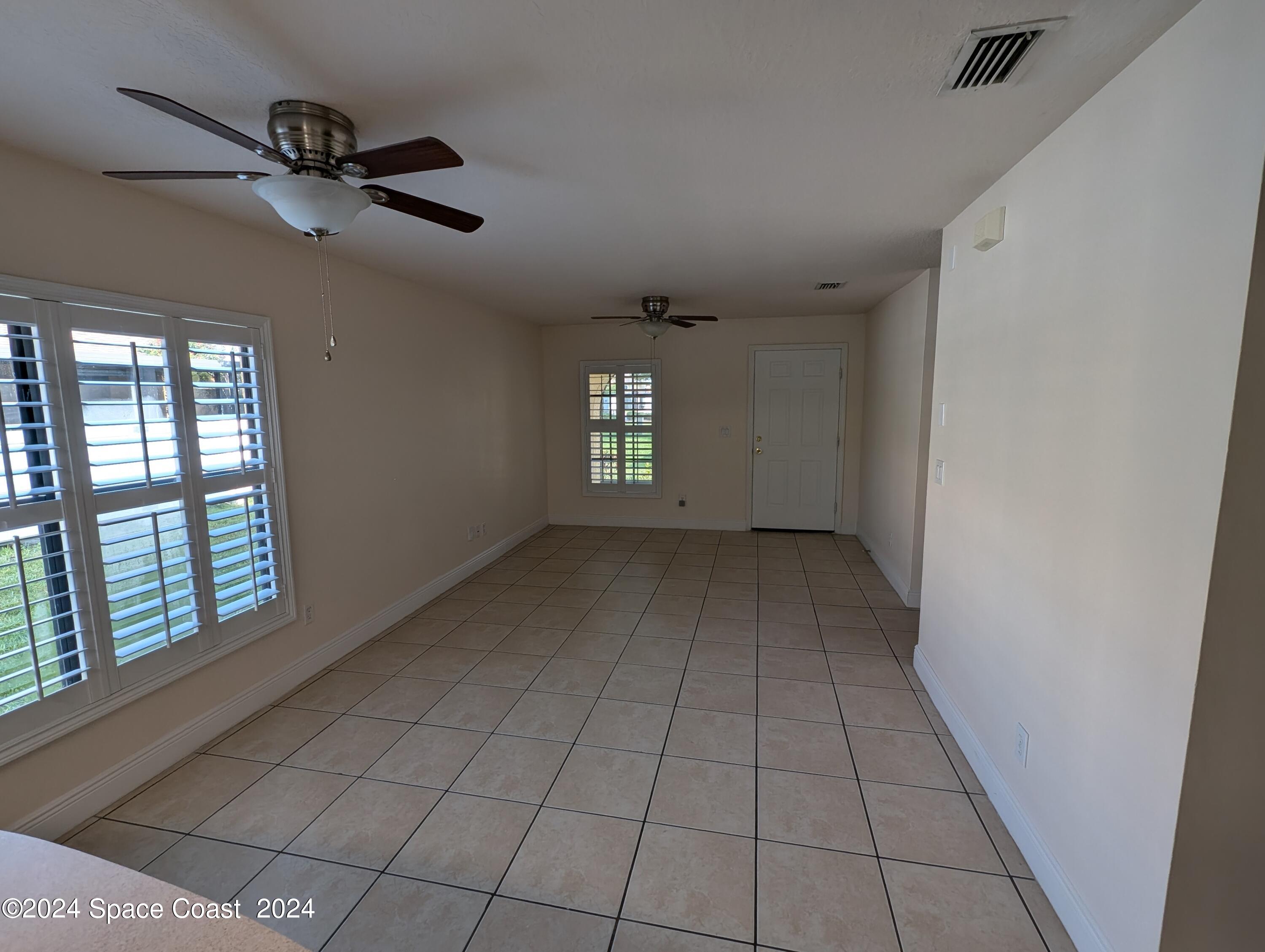 745 Luminary Circle, Unit 101 Melbourne, FL 32901 - Photo 6 of 32 a view of an empty room with a window