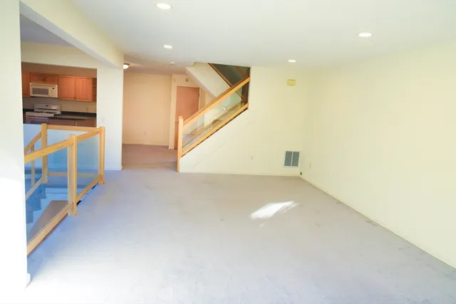 a view of a hallway with stairs