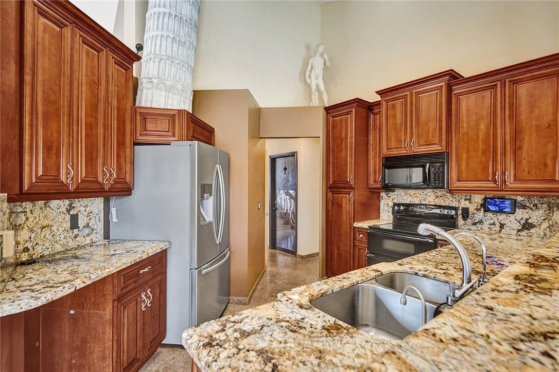 10576 Plainview Circle Boca Raton, FL 33498 - Photo 12 of 51 a kitchen with stainless steel appliances granite countertop a refrigerator stove and sink