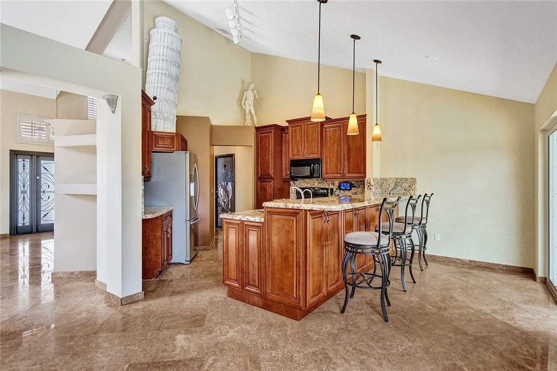 10576 Plainview Circle Boca Raton, FL 33498 - Photo 13 of 51 a view of kitchen with stainless steel appliances kitchen island microwave and refrigerator