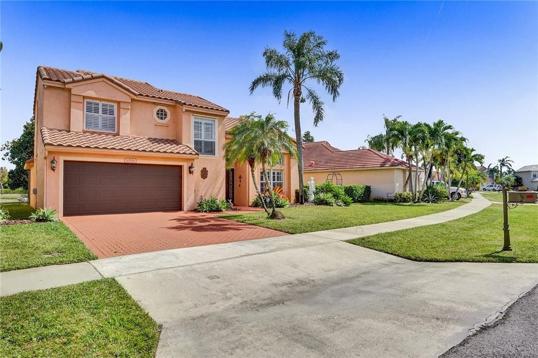 10576 Plainview Circle Boca Raton, FL 33498 - Photo 3 of 51 a front view of a house with a yard and garage