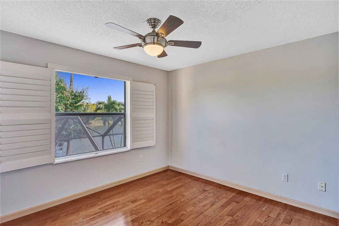 10576 Plainview Circle Boca Raton, FL 33498 - Photo 32 of 51 an empty room with wooden floor and windows