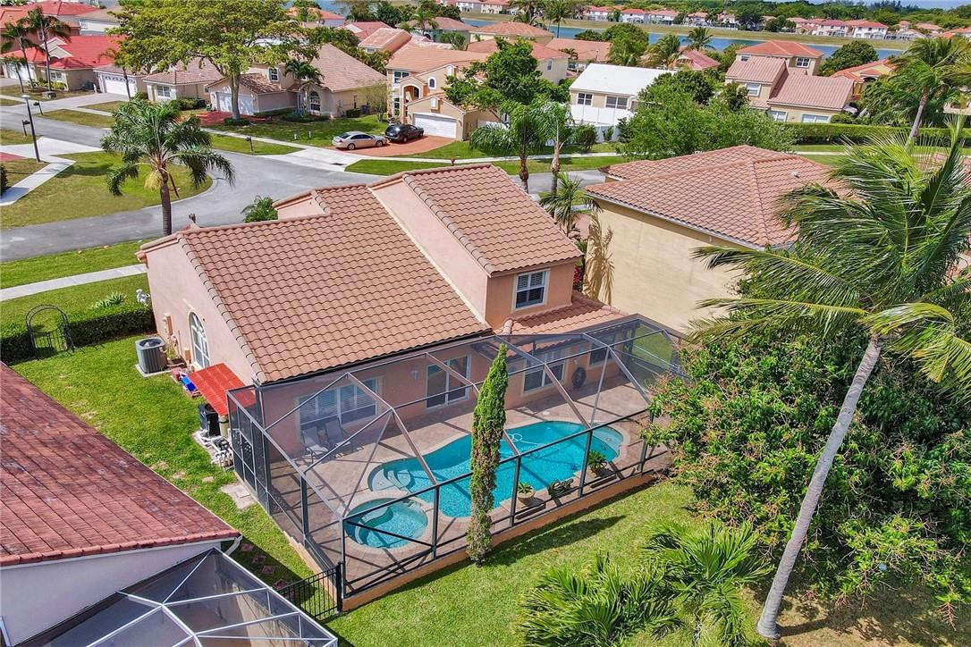 10576 Plainview Circle Boca Raton, FL 33498 - Photo 37 of 51 an aerial view of a house with swimming pool and a yard