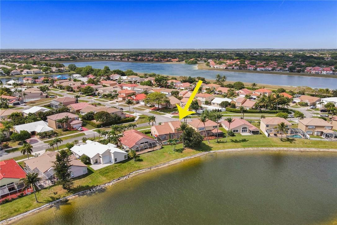 10576 Plainview Circle Boca Raton, FL 33498 - Photo 42 of 51 an aerial view of a city with lots of residential buildings ocean and mountain view in back