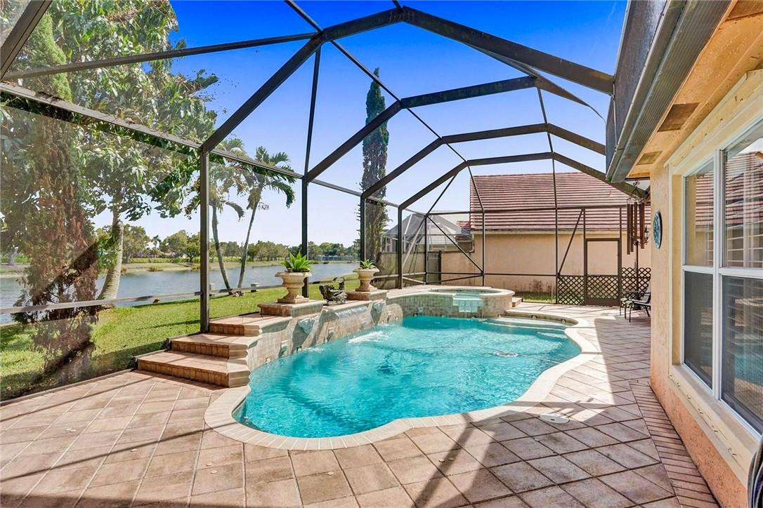 10576 Plainview Circle Boca Raton, FL 33498 - Photo 7 of 51 a view of a swimming pool with a patio