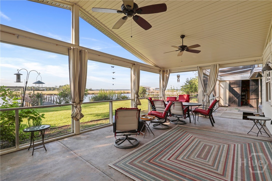 189 East 1st Street Midway, GA 31320 - Photo 22 of 50 Screened porch open to additional storage and a large hot tub.
