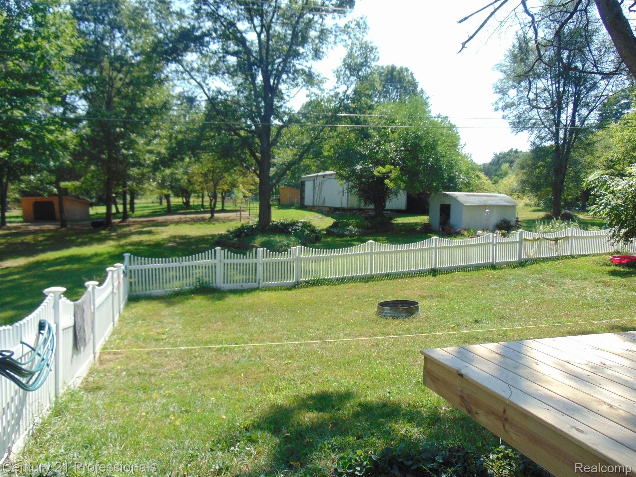 7222 Tucker Road Holly, MI 48442 - Photo 30 of 36 Maintenance Free White Fence around Part of the Backyard.....