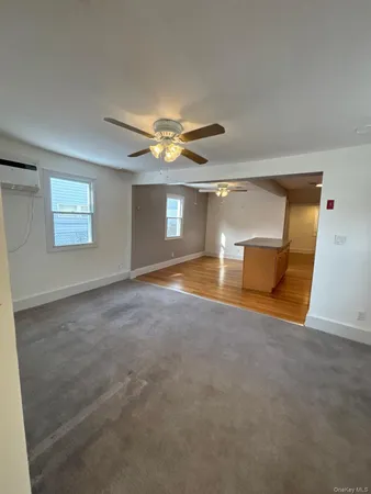a view of empty room with a ceiling fan and window