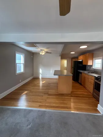 a view of kitchen and kitchen with granite countertop sink