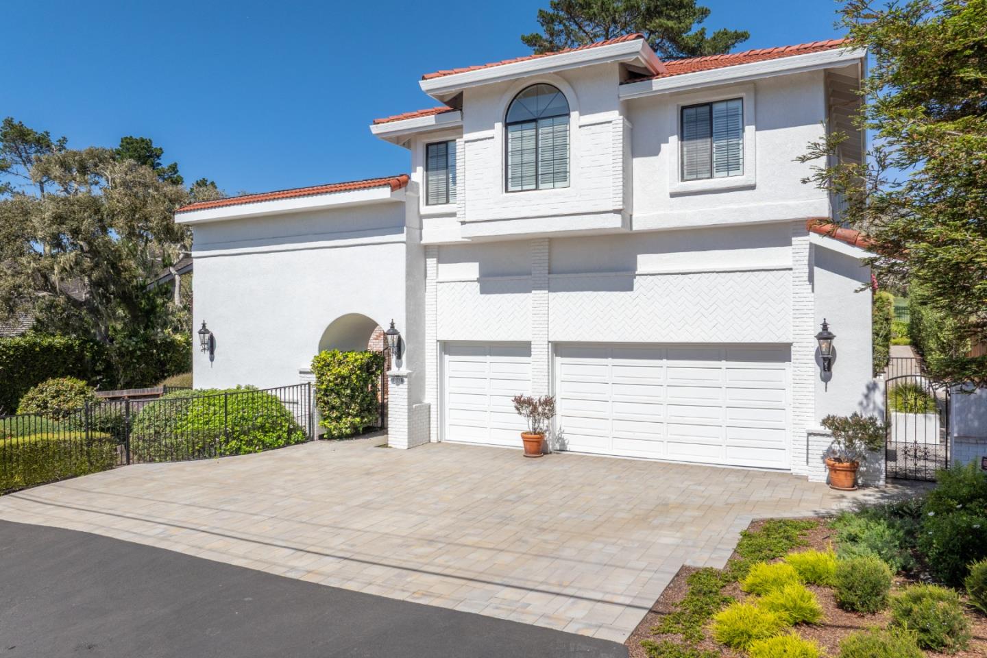 1043 Broncho Road Pebble Beach, CA 93953 - Photo 1 of 21 a front view of a house with a yard and garage