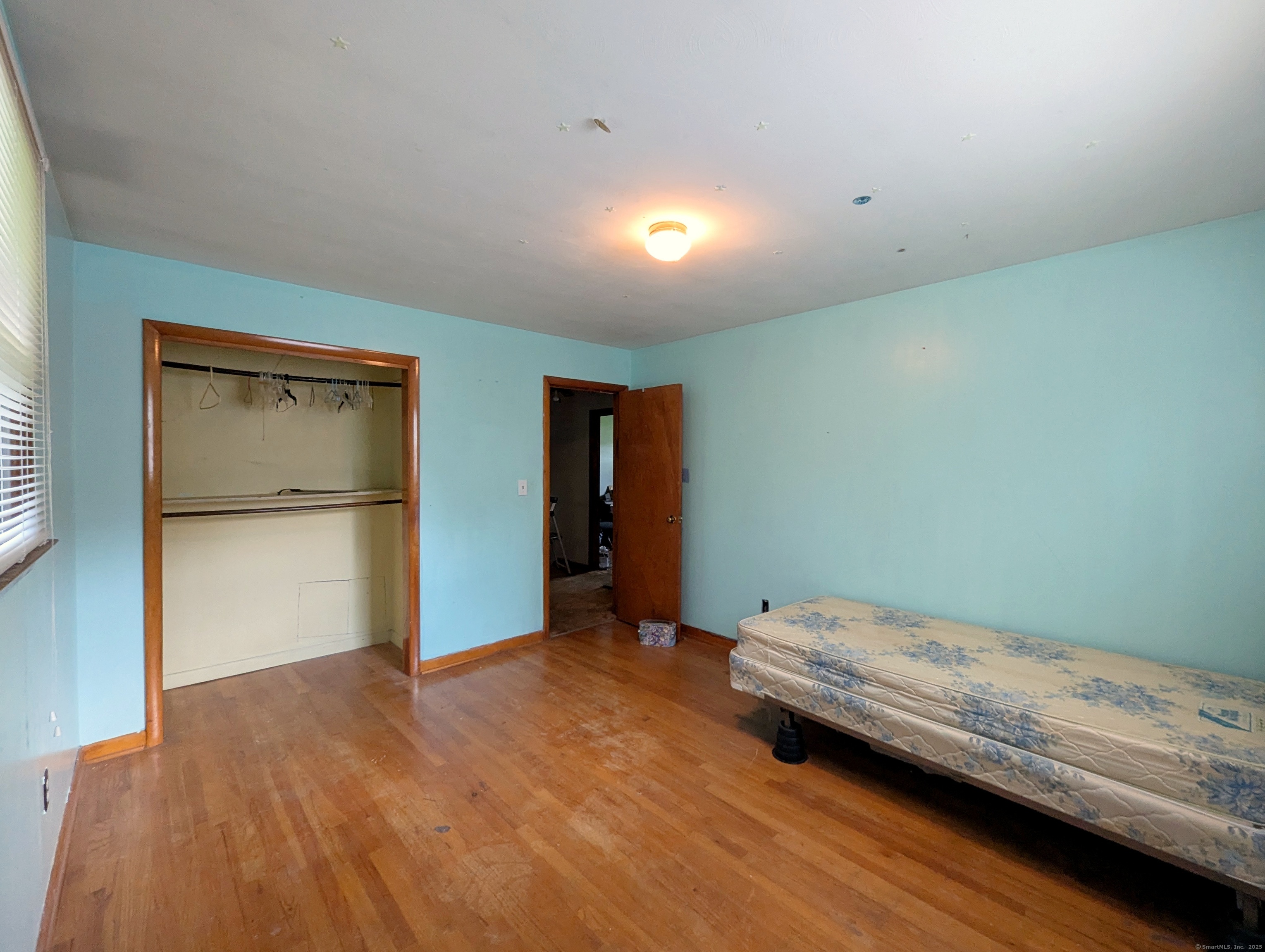 72 Morris Road Prospect, CT 06712 - Photo 18 of 27 a bedroom with a bed and wooden floor