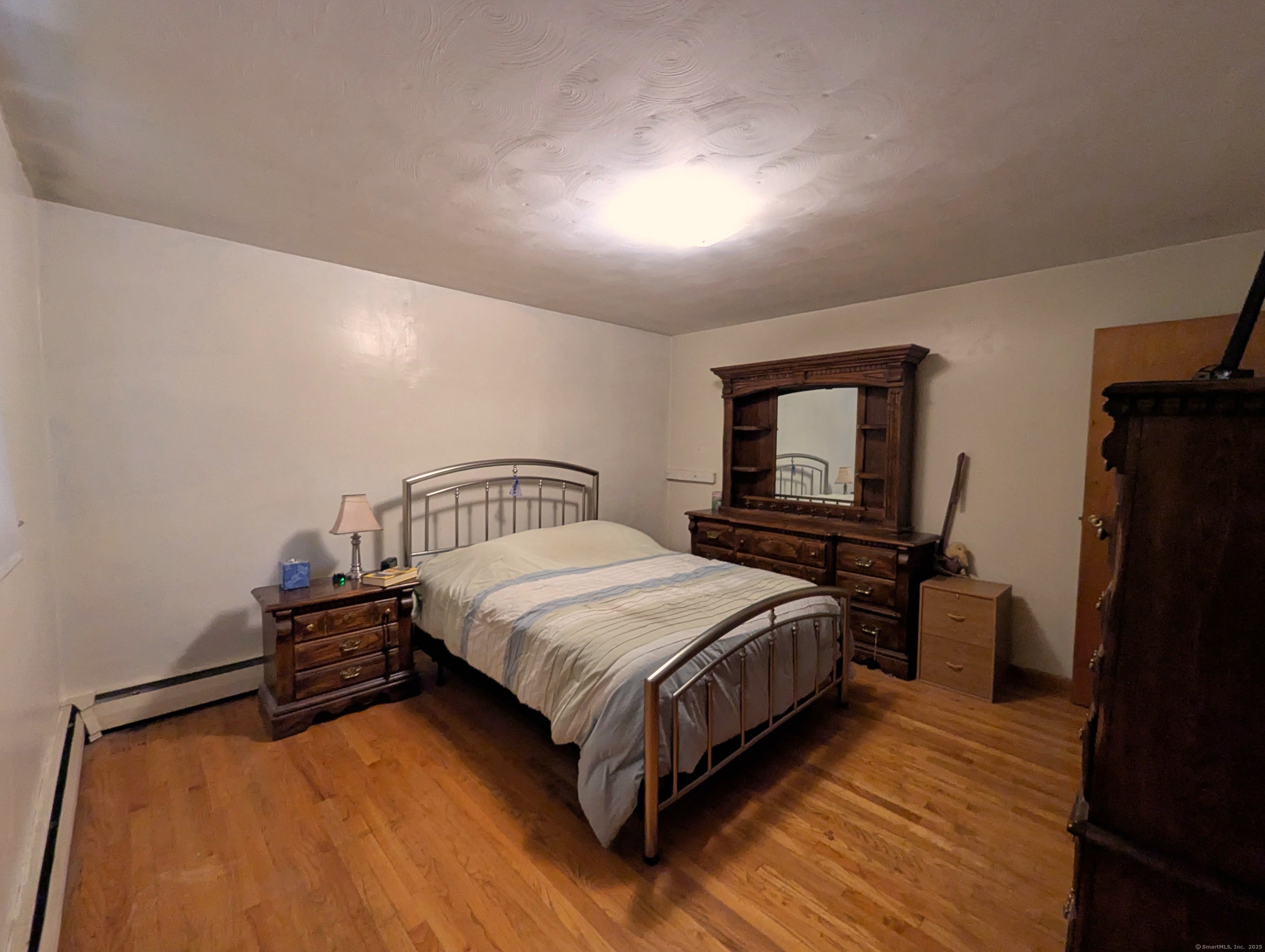 72 Morris Road Prospect, CT 06712 - Photo 19 of 27 a bedroom with a bed and a tv on table