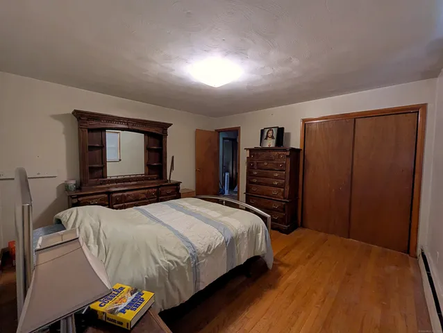 a bedroom with a bed and a television