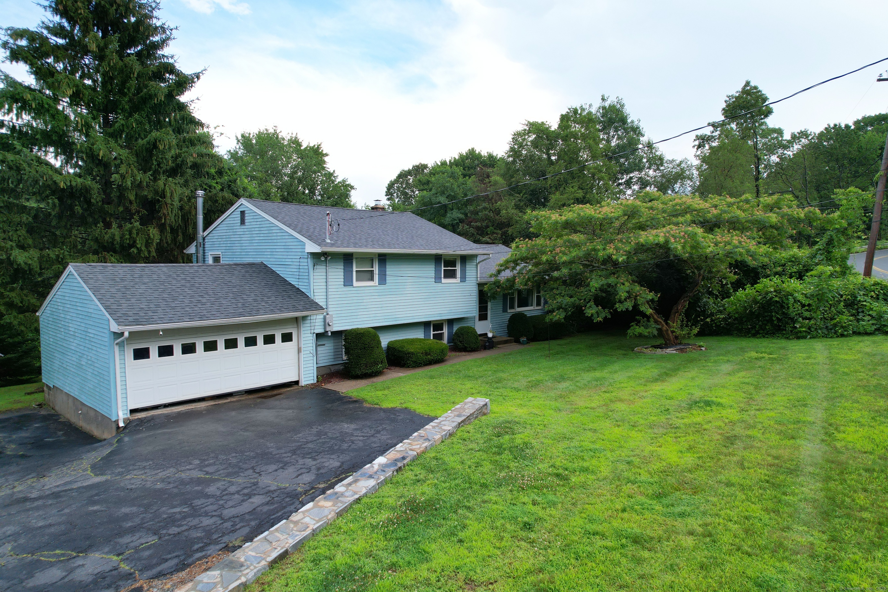 72 Morris Road Prospect, CT 06712 - Photo 2 of 27 a house with a big yard and large trees
