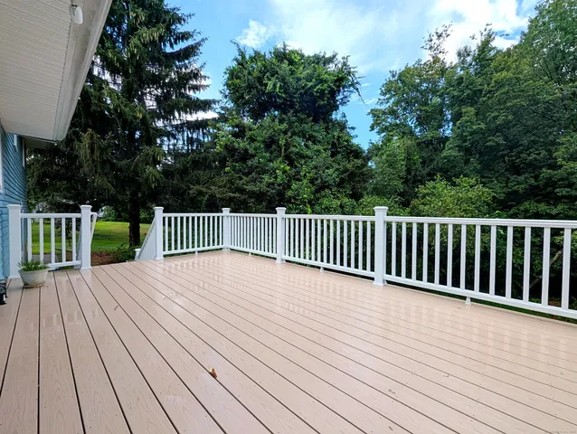 a view of deck with wooden floor and fence