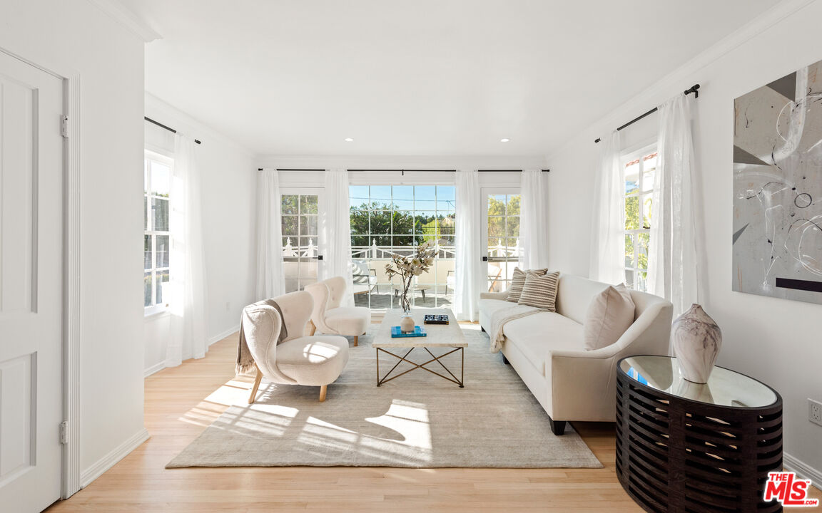 625 Sierra Drive Beverly Hills, CA 90210 - Photo 12 of 25 a living room with furniture and a large window