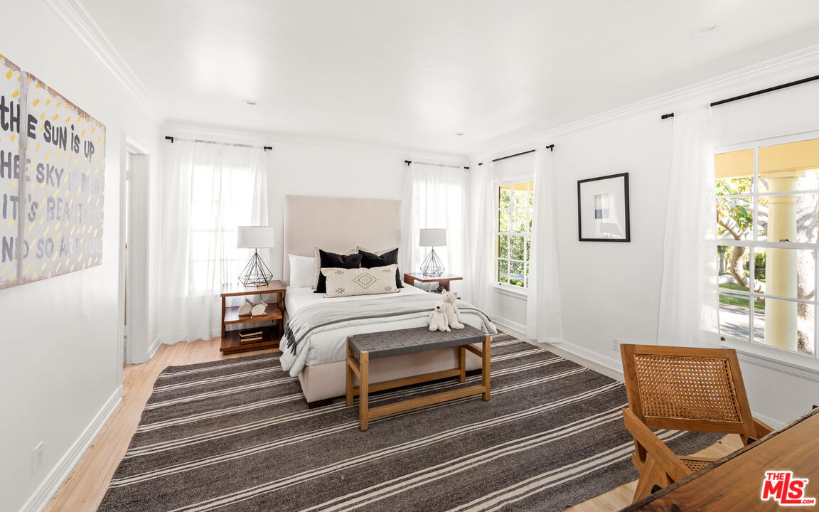 625 Sierra Drive Beverly Hills, CA 90210 - Photo 14 of 25 a bedroom with a bed and wooden floor