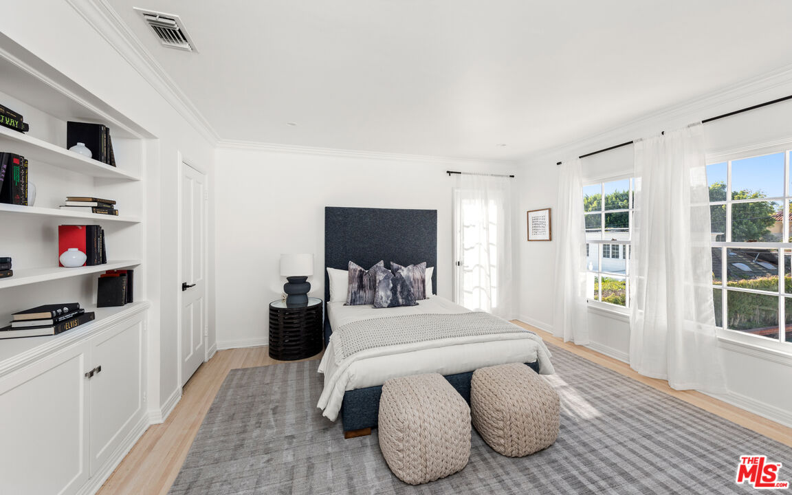 625 Sierra Drive Beverly Hills, CA 90210 - Photo 19 of 25 a bedroom with furniture and a window