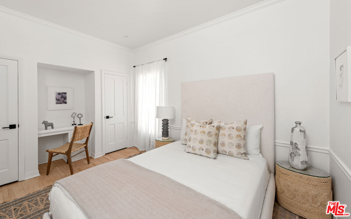 625 Sierra Drive Beverly Hills, CA 90210 - Photo 20 of 25 a bedroom with a bed and a chair