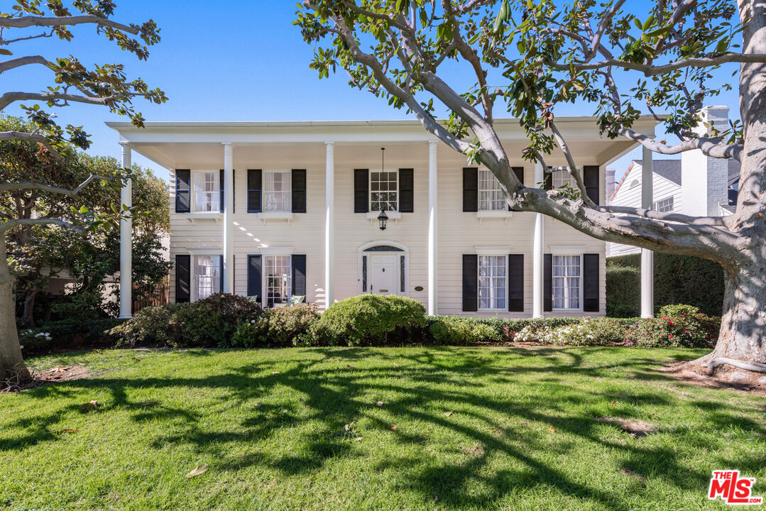 625 Sierra Drive Beverly Hills, CA 90210 - Photo 22 of 25 a front view of a house with a yard