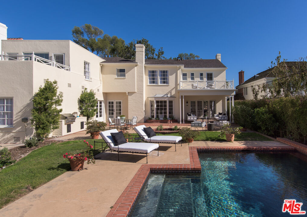 625 Sierra Drive Beverly Hills, CA 90210 - Photo 24 of 25 a view of a house with swimming pool and sitting area