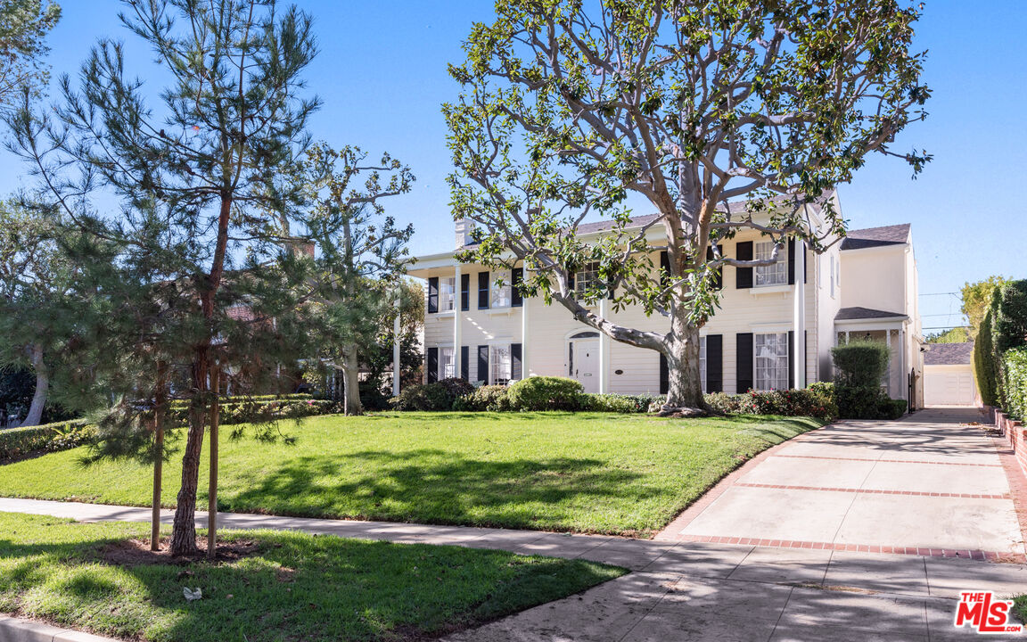 625 Sierra Drive Beverly Hills, CA 90210 - Photo 25 of 25 a view of a white house with a big yard and large trees